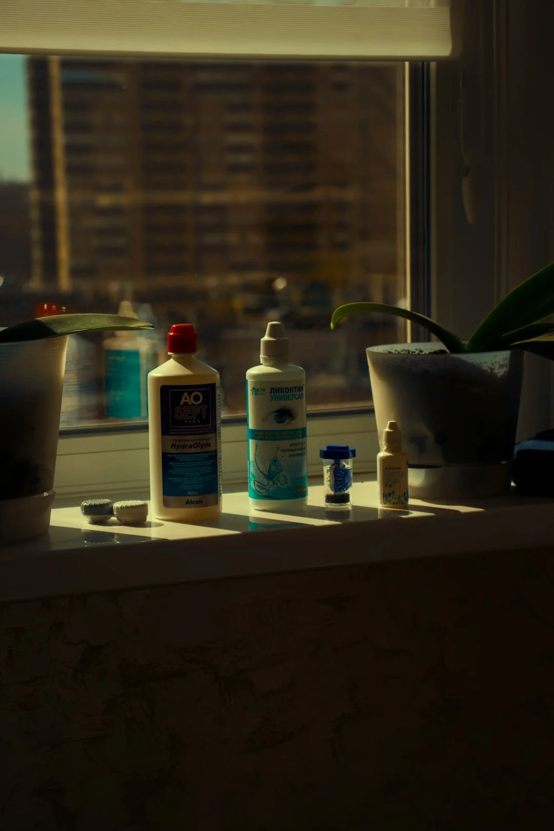 A stack of moving boxes in a room filled with sunlight, suggesting the beginning of a new chapter in a new apartment.